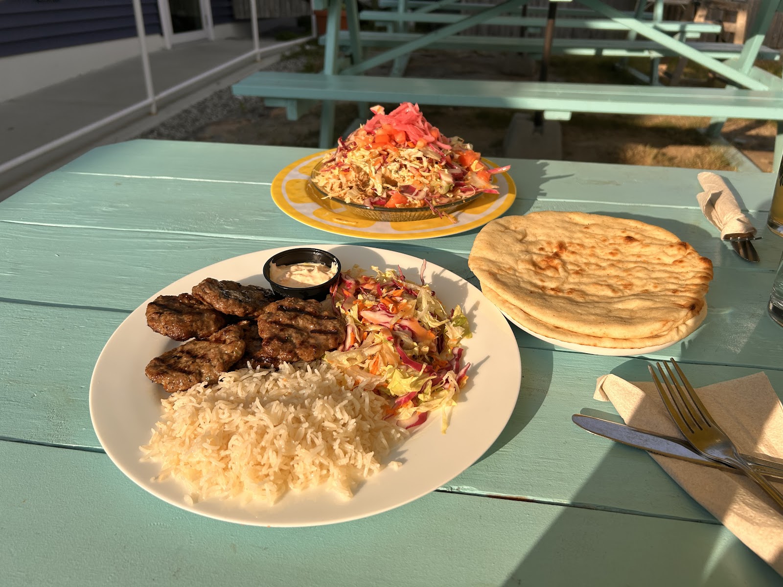 Several plated foods on a turquoise table